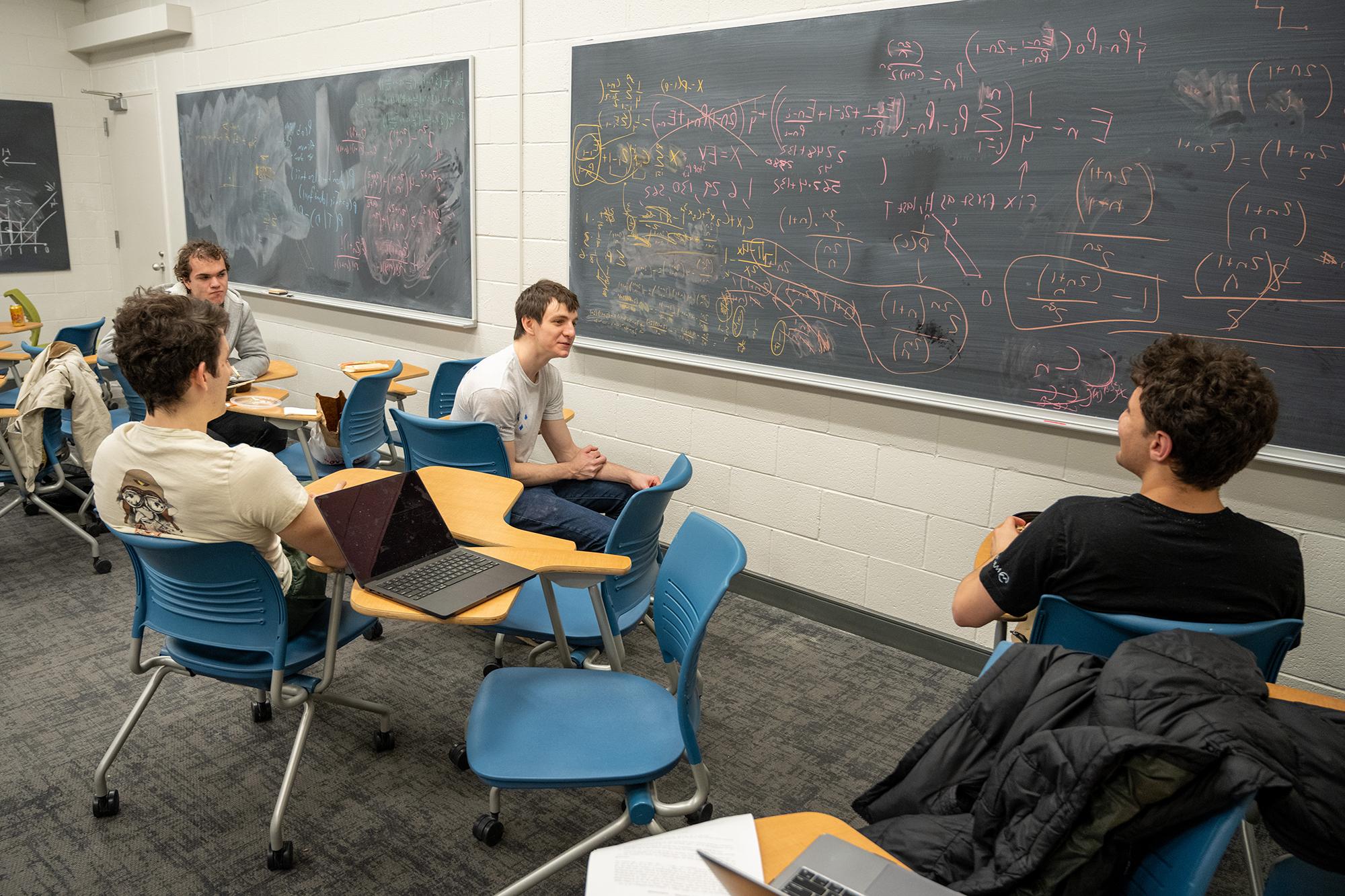 Harrison Wiseblatt, Mario Tutuncu-Macias, Gil Shteyman and Max Grebinskiy sit and discuss the problem